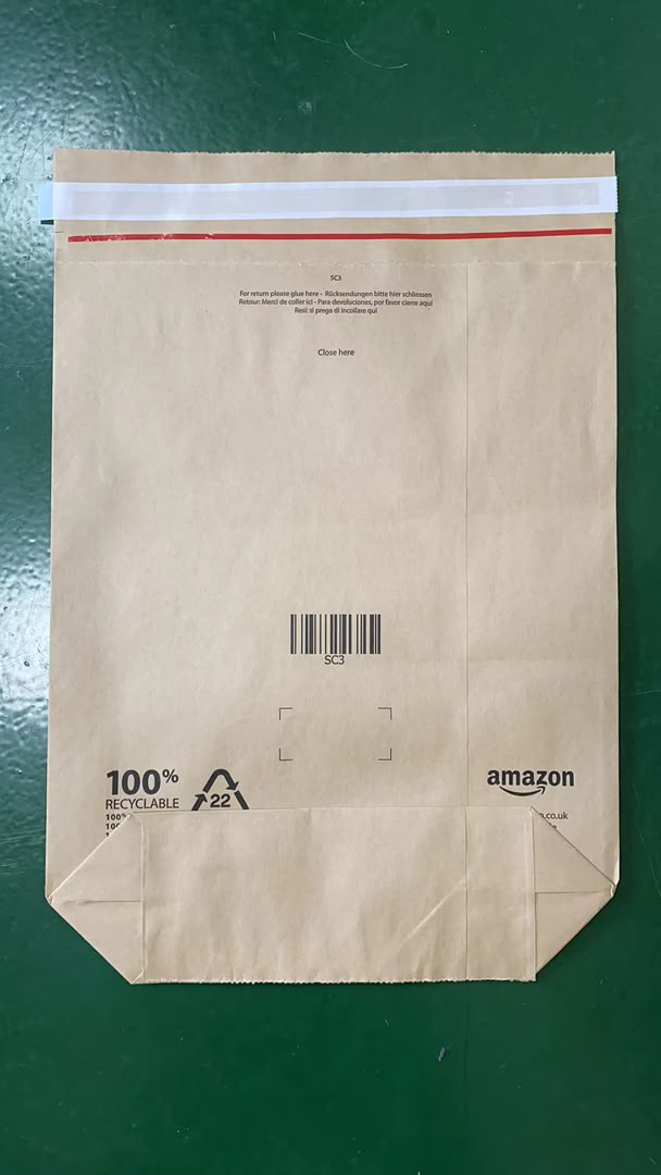 Back of Amazon kraft paper mailer: 100% recyclable claim, PAP 22 recycling symbol, multilingual open and return instructions, SC3 barcode